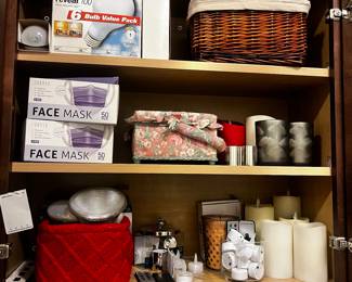 Mixed Home Decor and Household Items including Floral Fabric Boxes, Decorative Candles, Face Masks, and Storage Basket