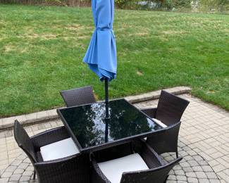 table with 4 chairs and umbrella 