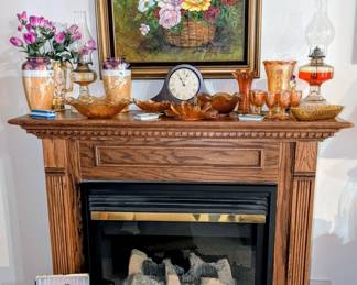 Large electric fireplace with wood mantle.