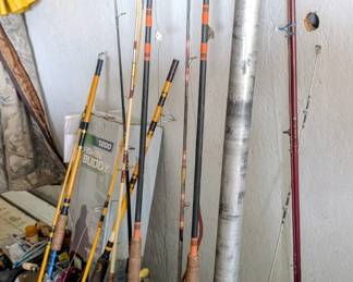 Many fishing rods and fishing reels.