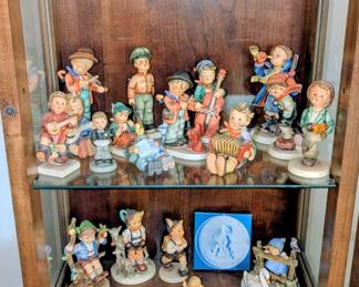 Many vintage Hummel figurines with original boxes.