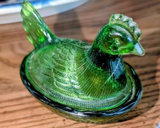 Vintage small green hen on nest.