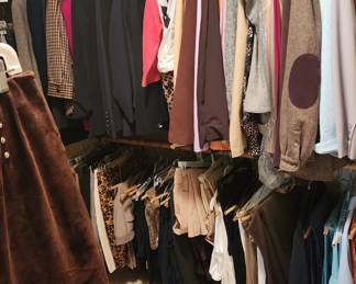 Inside women's closet:  dresses, suits, pants, blouses, jackets, skirts, camisoles