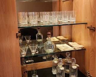 Inside of the Henredon Scene Two bar cabinet, Belleck vases and crystal bar ware pictured   