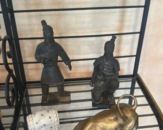 collection of Porcelain Figurines and Decorative Items on a Metal Shelf Unit 