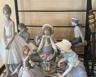 Collection of Porcelain Figurines and Decorative Items on a Metal Shelf Unit 