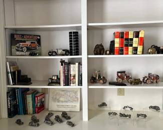 A large collection of pewter cars