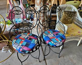 John Risley style picasso face wrought iron chairs