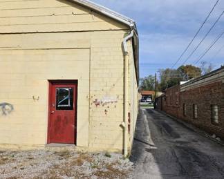 Red door is the entrance for the sale