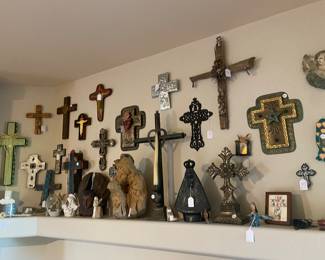 A large selection of religious decor, including crucifixes, nativity scenes, santos, and other folk art