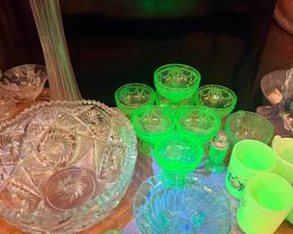 Vintage Uranium Glass Collection – Bowls, cups, and tumblers glowing under blacklight, classic Depression glass display.