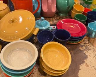 Fiesta Ware Collection – Assorted vintage ceramic bowls, plates, pitchers, and teapots in multiple colors, classic collectible dinnerware.