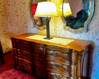This is an exquisite long low dresser made by The Continental Furniture Company in High Point, NC. They specialized in high quality, solid wood furniture and was founded in 1901, closing its doors in the 1950s. You can't find this quality anymore. This dresser measures 65.5" wide, 21.5" deep and 33" high in excellent condition.