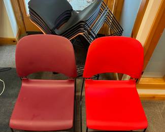 Eight Herman Miller “Limerick” stacking chairs designed by Tom Newhouse. Includes rolling storage rack.