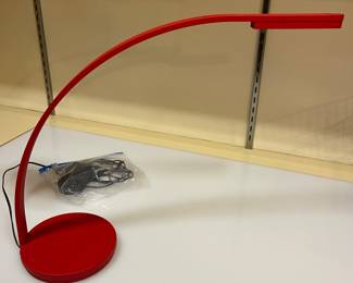 Arching red desk lamp by OFS Brands.