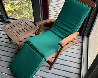 One of two matching Smith & Hawken teakwood steamer chairs and side tables.