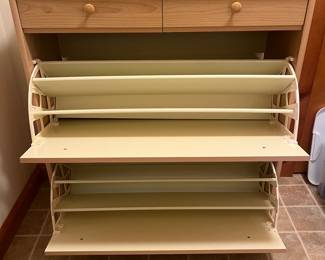 View of the inside of the wooden shoe cabinet.