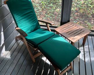One of two matching Smith & Hawken teakwood steamer chairs and side tables.