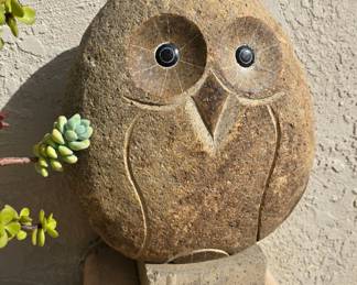 Carved stone owl statue