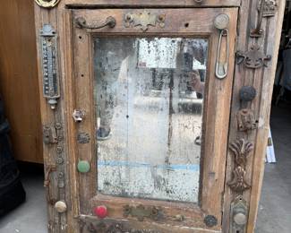 Steampunk antique cabinet with knobs, thermometer, safety pin, key lock, letter slot, etc.