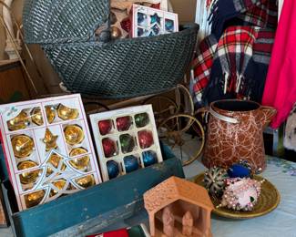 Antique buggy, boxes of ornaments, vintage sequined napkins, terracotta nativity, beaded ornaments, enamelware pitcher, plaid blankets.