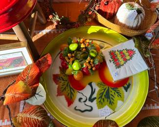 Fall decor including garland, tin tray, candle ring, vintage napkins, chenille pumpkins, foot stool, wreath, etc.