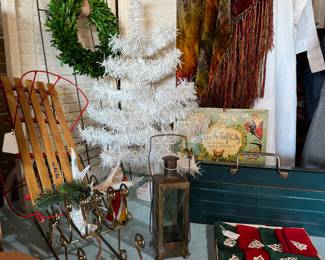 Vintage Christmas tree, velvet tie die throw blanket, toolbox, christmas napkins, bells, sleds, wreaths, green glass lantern.