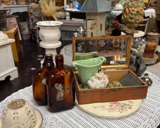 Wicker table, antique bottles, green ceramic planter and more