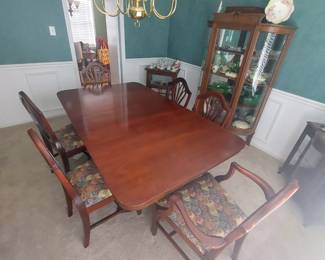 Cherry dining room table with one leaf and six matching chairs