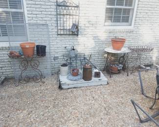 large variety of planters, shepherds' hooks, and garden supplies