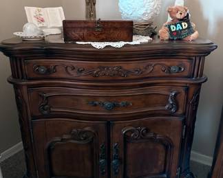 Wood nightstand with cabinets and drawers.