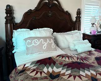 Carved dark wood bed frame with split electric raising mattresses and throw pillows