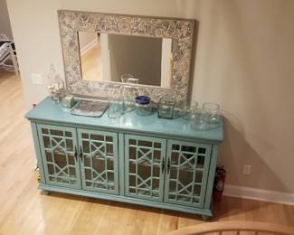 Glass front media console; large wall mirror