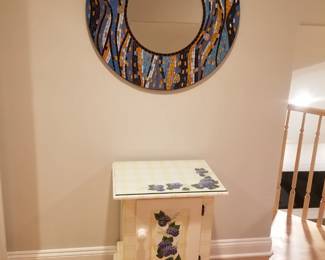 Mosaic wall mirror; painted cupboard 