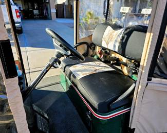 Golf Cart for sale. Come in and place a bid at the register. New 2025 enclosure, flip folding back seat, gas powered, totally street legal, headlights, tail lights, blinkers, 2014 refurbished. Runs beautiful!