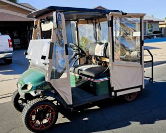 Golf Cart for sale. Come in and place a bid at the register. New 2025 enclosure, flip folding back seat, gas powered, totally street legal, headlights, tail lights, blinkers, 2014 refurbished. Runs beautiful!