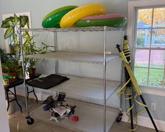 Pool floats; metal rolling rack; volleyball net