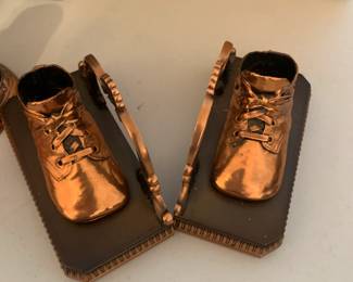 #113	bronze baby bootie book ends 	 $20.00 
