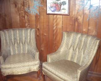 Matching tufted chairs showing wear