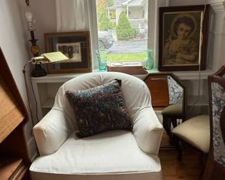 Slipcovered armchair, brass floor lamp, custom framed art, mirror