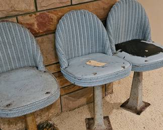Very cool rattan boat chairs, cast iron bases