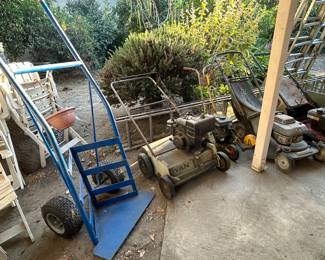 Giant plant moving hand truck and multiple lawnmowers