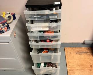 R33 - $25. Plastic Organizer with contents (small tools, household items, picture hanging accessories, extension cords etc). 