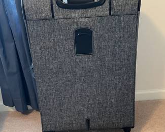 R57 - $35. London Fog large suitcase with 4 spinner wheels. Measures 20" x 12" x 31" tall. Very good condition!