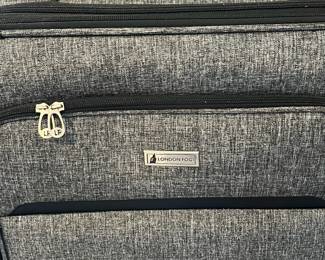 R57 - $35. London Fog large suitcase with 4 spinner wheels. Measures 20" x 12" x 31" tall. Very good condition!