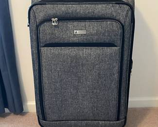 R57 - $35. London Fog large suitcase with 4 spinner wheels. Measures 20" x 12" x 31" tall. Very good condition!