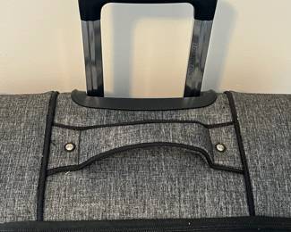 R57 - $35. London Fog large suitcase with 4 spinner wheels. Measures 20" x 12" x 31" tall. Very good condition!