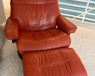Red leather armchair with ottoman.