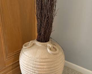 Decorative large beige vase with faux twigs.