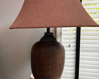 Table lamp with red shade. Pewter based with textured speckles.